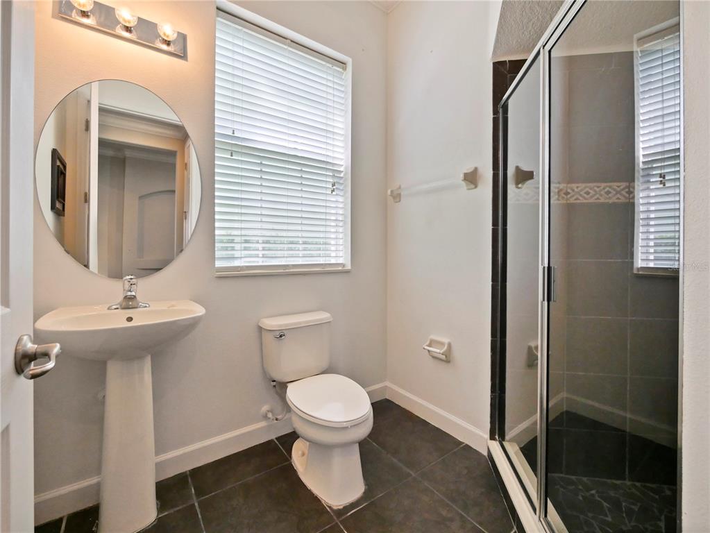 7710 Linkside Loop Reunion, FL 34747 - Photo 19 of 33 a bathroom with a toilet sink and shower