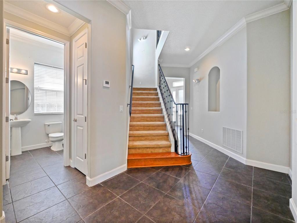 7710 Linkside Loop Reunion, FL 34747 - Photo 20 of 33 a view of entryway with stairs and a front door