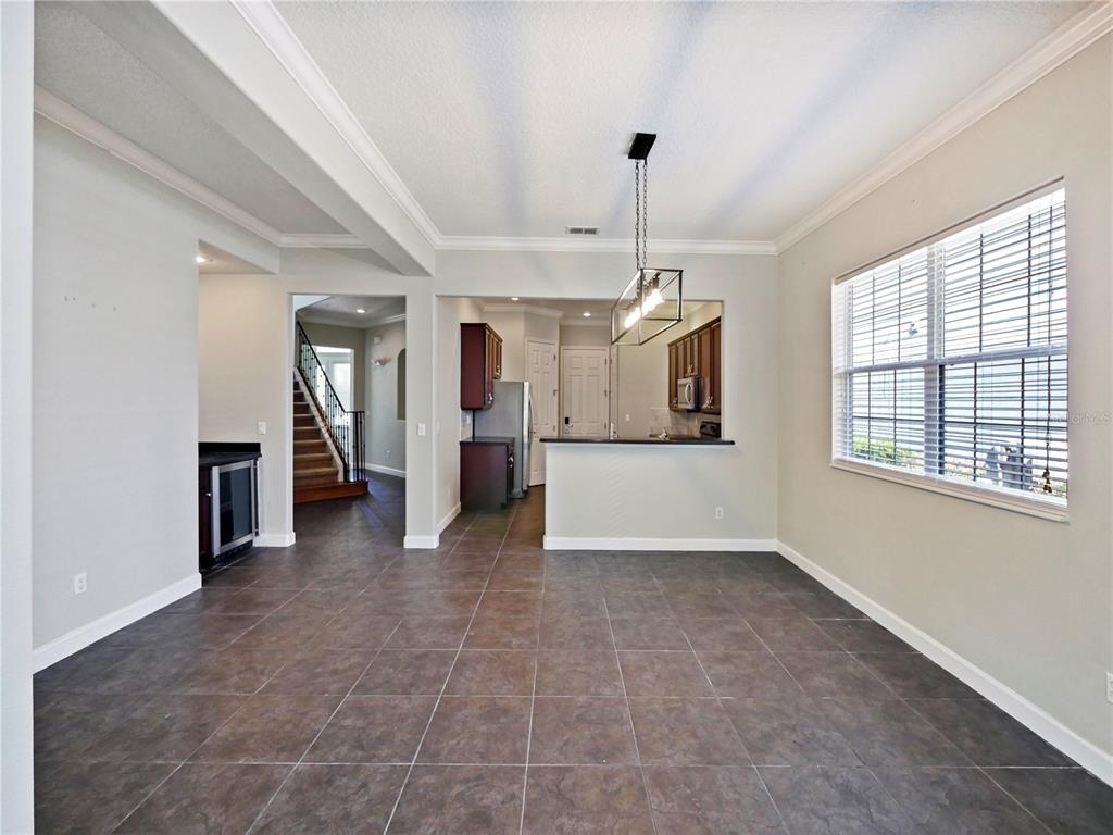 7710 Linkside Loop Reunion, FL 34747 - Photo 22 of 33 a view of a kitchen with a sink and dishwasher a refrigerator with wooden floor