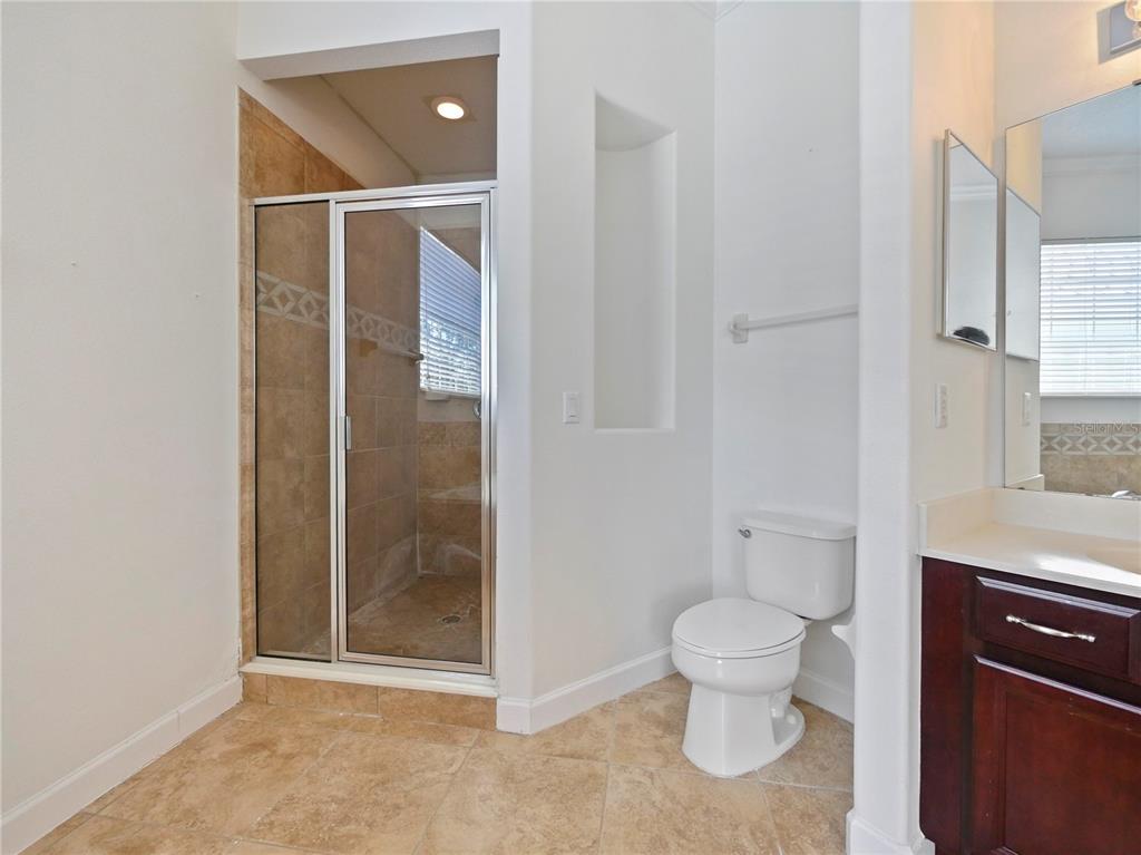 7710 Linkside Loop Reunion, FL 34747 - Photo 31 of 33 a bathroom with a toilet and a shower