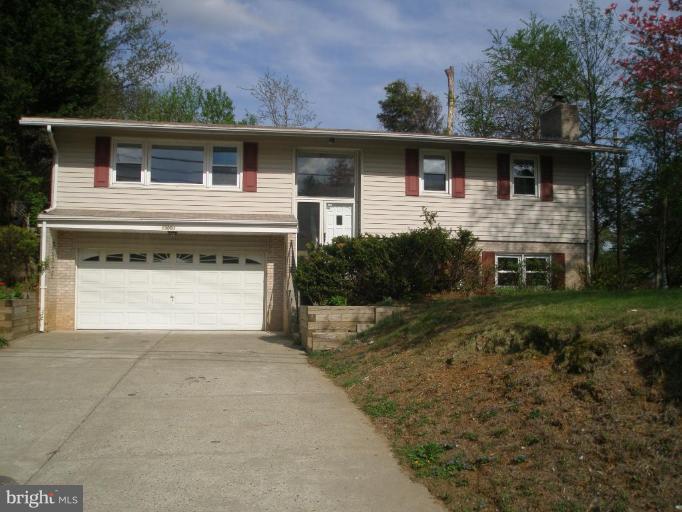 13001 Layhill Road Silver Spring, MD 20906 - Photo 1 of 19 a front view of a house with a yard and garage
