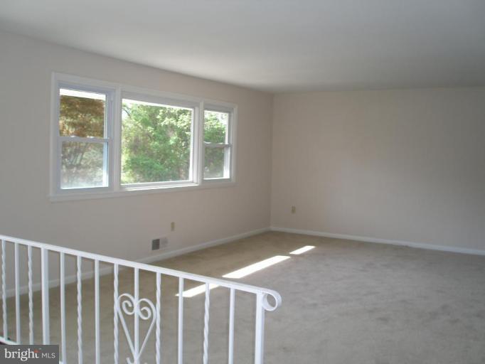 13001 Layhill Road Silver Spring, MD 20906 - Photo 11 of 19 a view of an empty room with wooden floor and windows