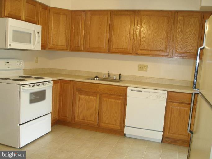 13001 Layhill Road Silver Spring, MD 20906 - Photo 14 of 19 a utility room with sink dryer and washer