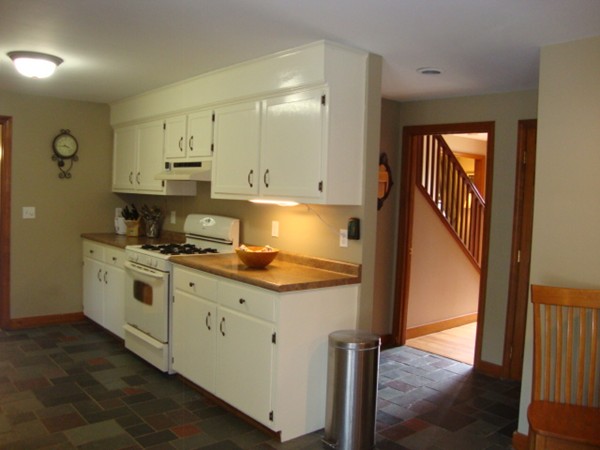 228 Braley Hill Road Rochester, MA 02770 - Photo 11 of 18 a kitchen with stainless steel appliances granite countertop a stove a sink and a refrigerator