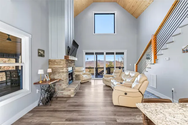 a living room with fireplace furniture and a flat screen tv