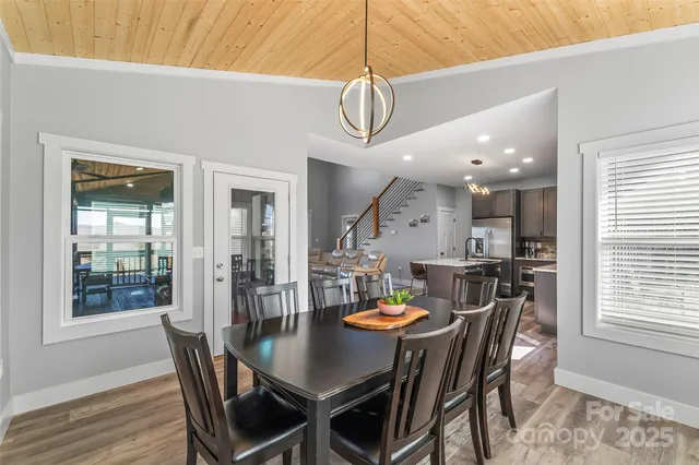 a view of a dining room and livingroom with furniture wooden floor and a rug