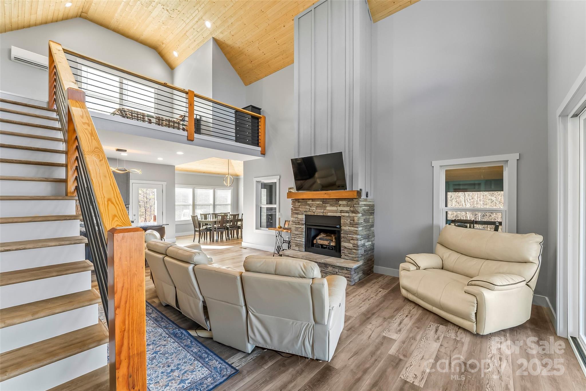 53 Cres Ridge Lane Nebo, NC 28761 - Photo 18 of 48 a living room with furniture a fireplace and a flat screen tv