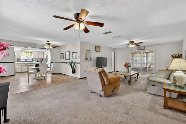 a living room with furniture and kitchen view