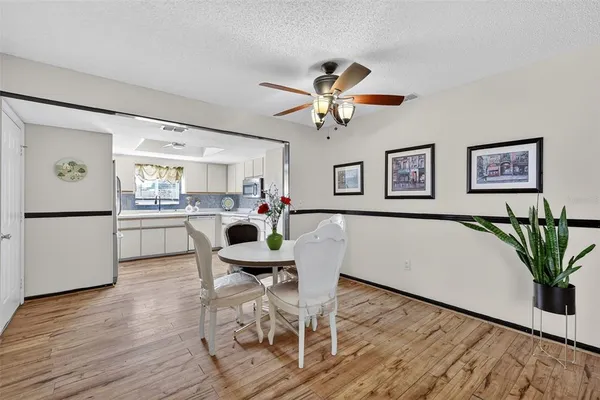 a view of a dining room with furniture and wooden floor