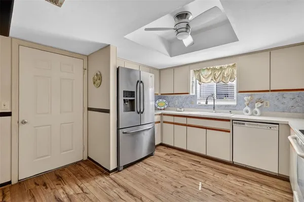 a kitchen with stainless steel appliances granite countertop a refrigerator and a sink