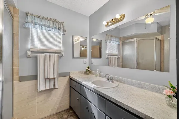 a bathroom with a granite countertop sink and a mirror