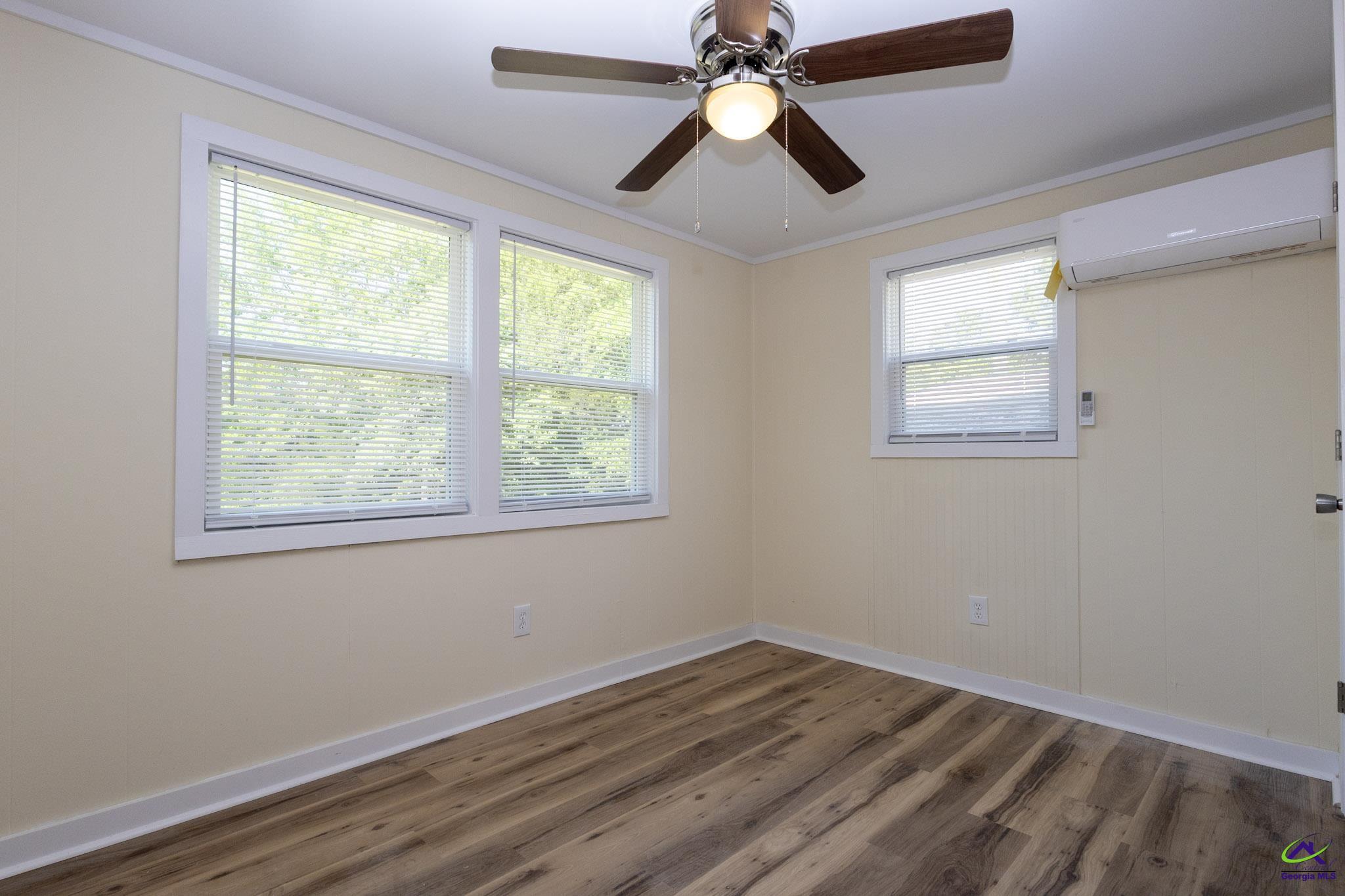 156 Churchwell Road Cochran, GA 31014 - Photo 17 of 20 a view of empty room with wooden floor and fan