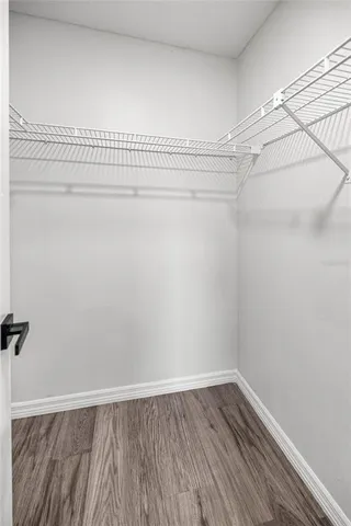 a view of a room with wooden floor