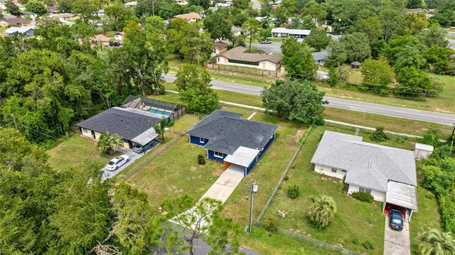 an aerial view of residential houses with outdoor space and street view