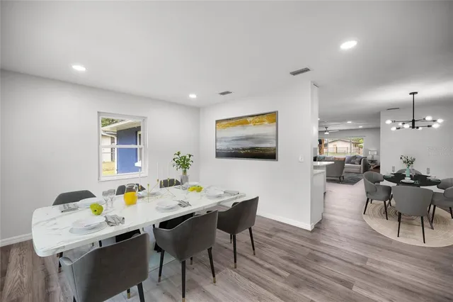 a view of a dining room with furniture and wooden floor