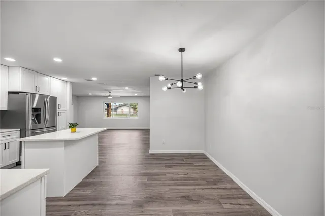 a view of kitchen with sink microwave and refrigerator