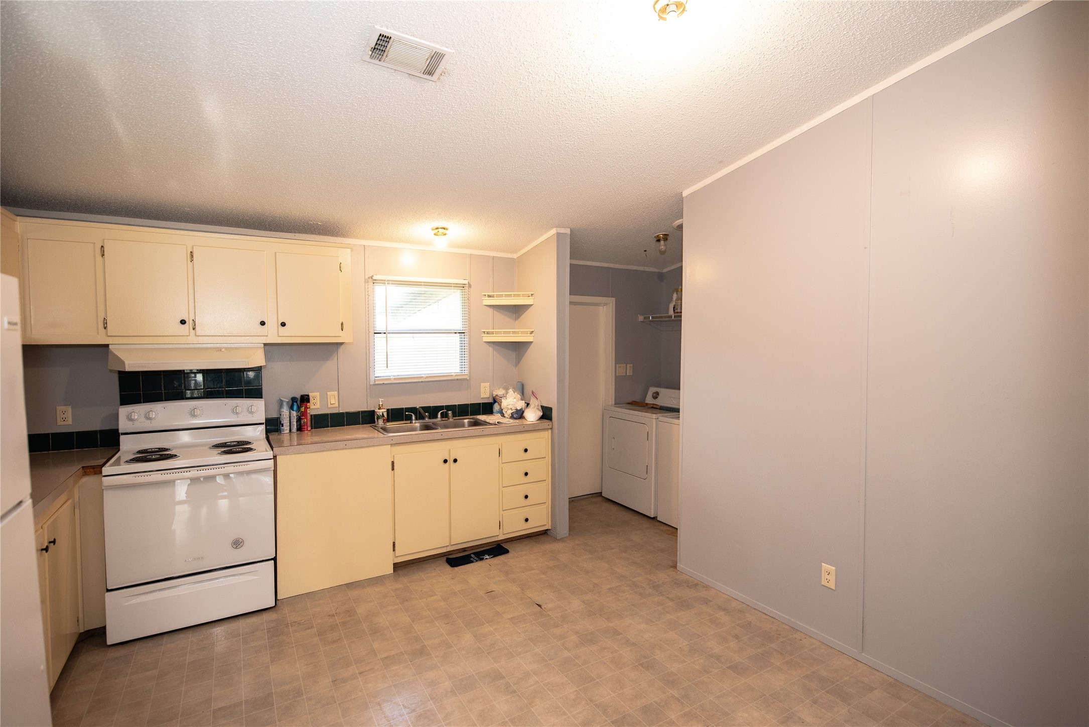 11804 Trickey Road Houston, TX 77067 - Photo 4 of 9 a kitchen with white cabinets and white appliances