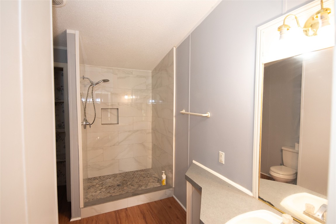 11804 Trickey Road Houston, TX 77067 - Photo 6 of 9 a bathroom with a shower and a toilet