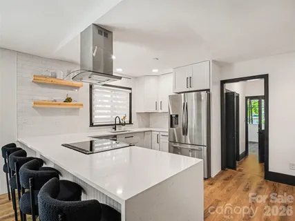 a kitchen with stainless steel appliances a sink and a refrigerator