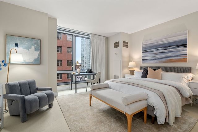 a bedroom with a bed and a couch