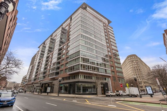 a view of a tall building next to a road