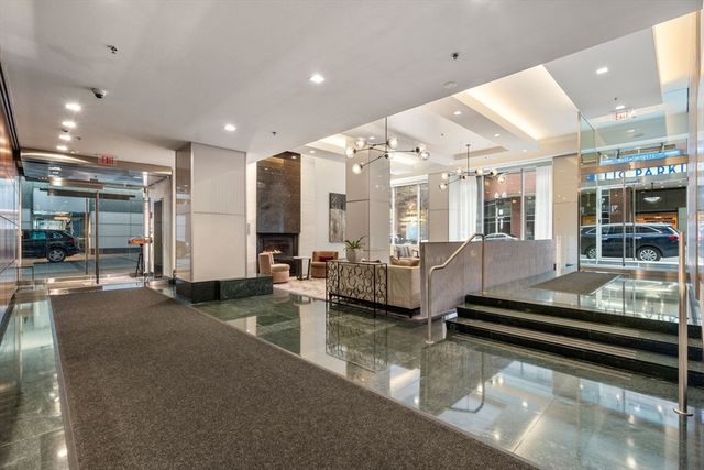 a living room with lots of furniture and a chandelier