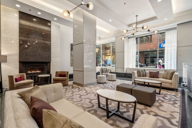 a living room with furniture and a chandelier