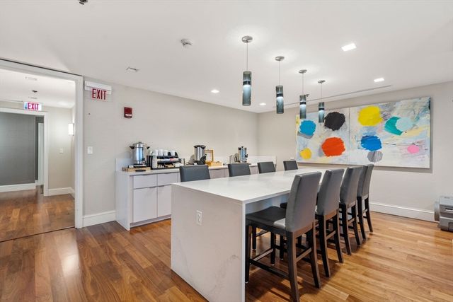 a kitchen with stainless steel appliances cabinets and wooden floor