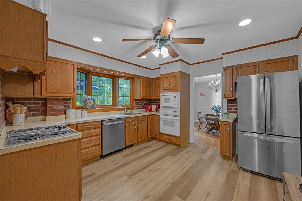 71 Morningside Road Worcester, MA 01602 - Photo 5 of 42 a kitchen with stainless steel appliances granite countertop a refrigerator a sink dishwasher a stove and white countertops with wooden floor