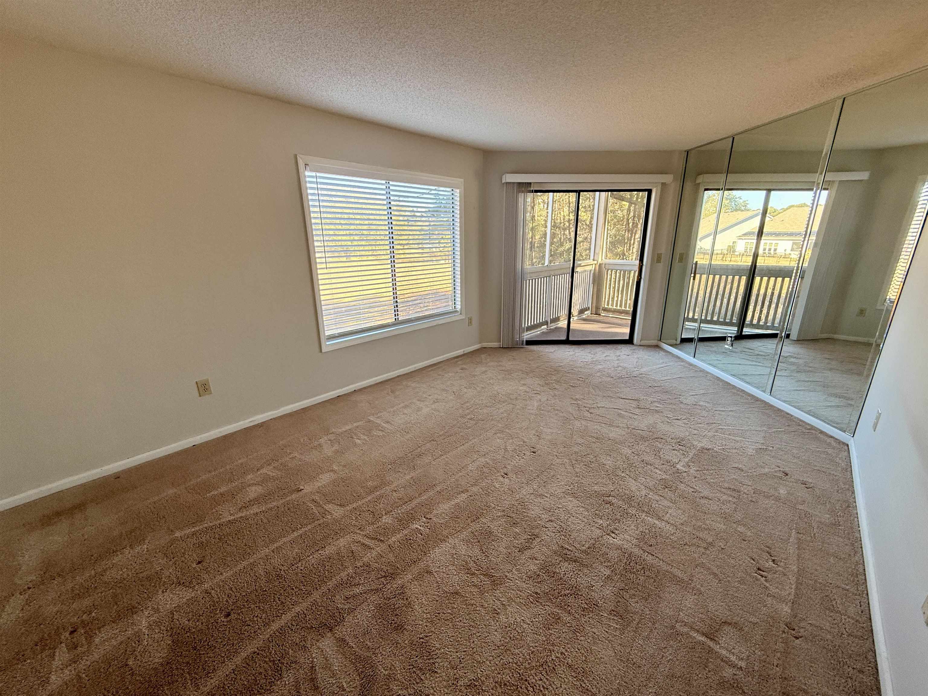 4230 Pinehurst Circle, Unit K4 Little River, SC 29566 - Photo 8 of 25 Carpeted empty room featuring a textured ceiling and baseboards