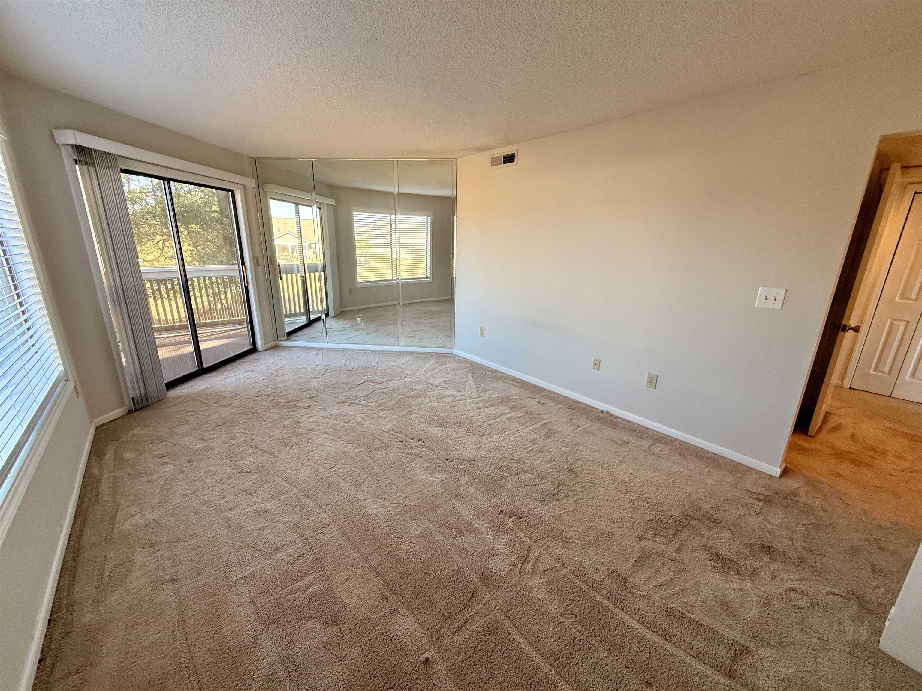 4230 Pinehurst Circle, Unit K4 Little River, SC 29566 - Photo 9 of 25 Carpeted spare room with a textured ceiling and baseboards