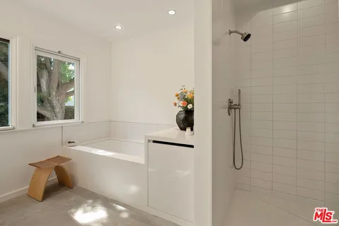 a bathroom with a bathtub and a shower