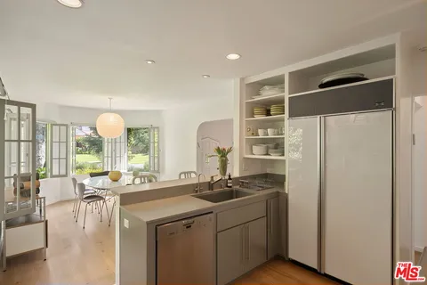 a kitchen with a sink appliances and living room