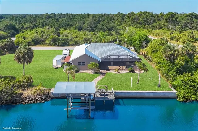 an aerial view of a house with swimming pool garden view and a lake view