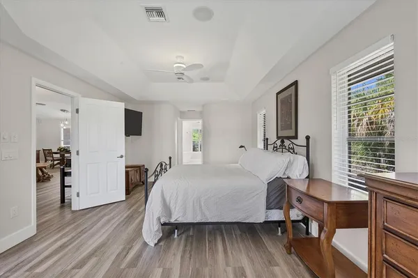 a spacious bathroom with a double vanity sink a large mirror and a bathtub