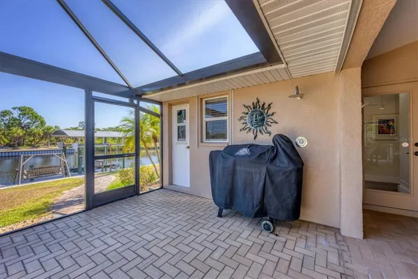 a view of a patio with table and chairs under an umbrella