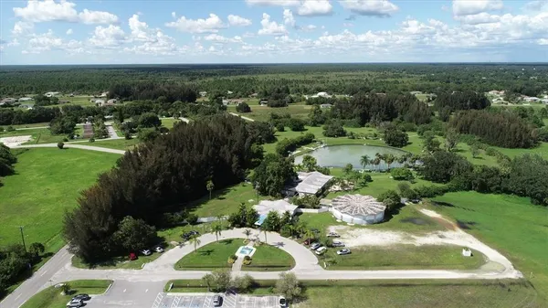 an aerial view of a house with a yard and lake view