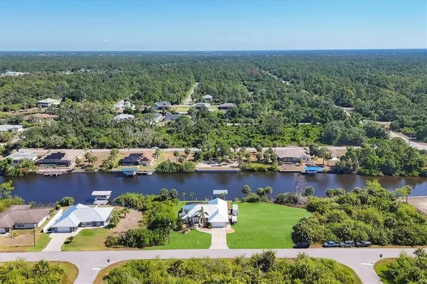 an aerial view of a house with a lake view