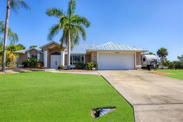 a front view of house with yard and outdoor seating