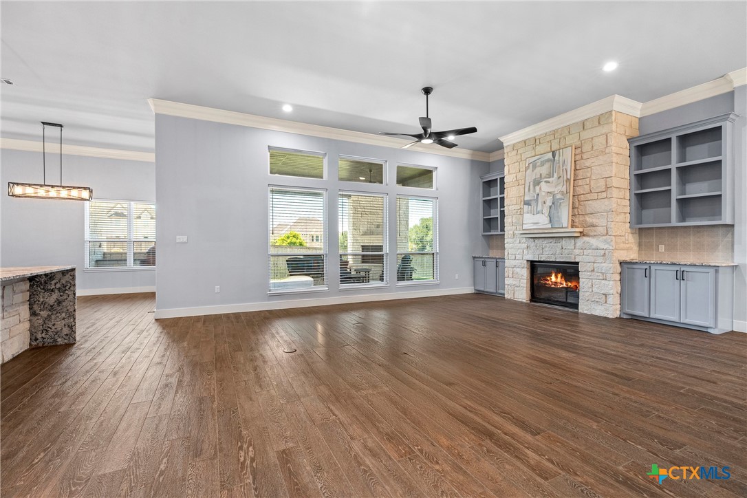1606 Alta Vista Loop Temple, TX 76502 - Photo 14 of 48 an empty room with windows fireplace and wooden floor