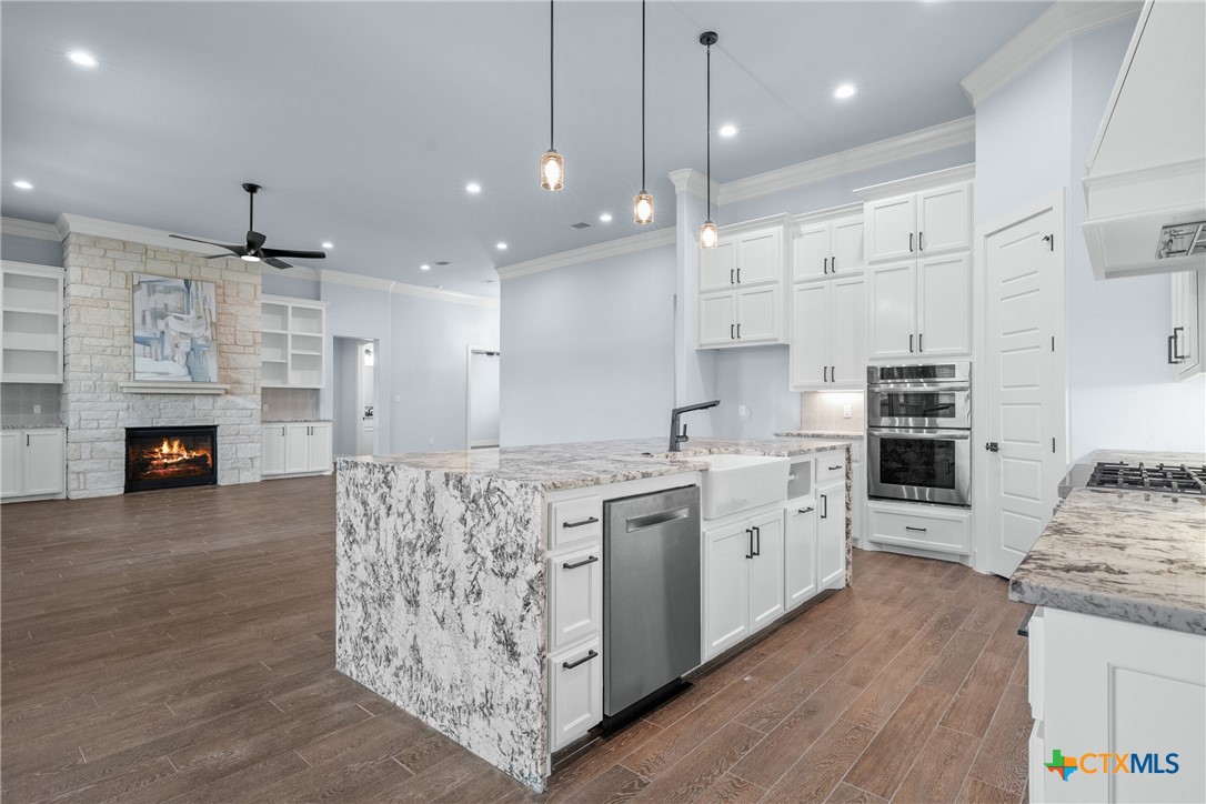 1606 Alta Vista Loop Temple, TX 76502 - Photo 16 of 48 a large kitchen with stainless steel appliances granite countertop a stove oven and a wooden floors
