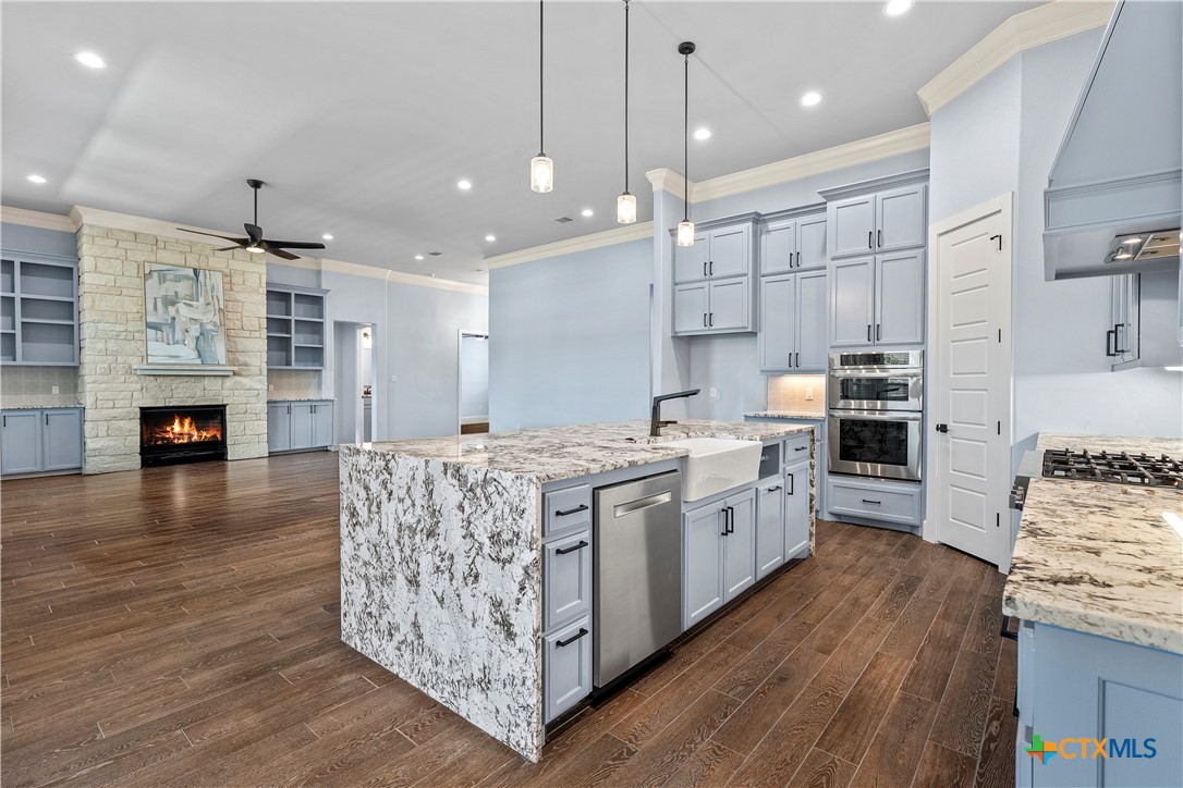 1606 Alta Vista Loop Temple, TX 76502 - Photo 17 of 48 a large kitchen with stainless steel appliances granite countertop a lot of counter space and wooden floors
