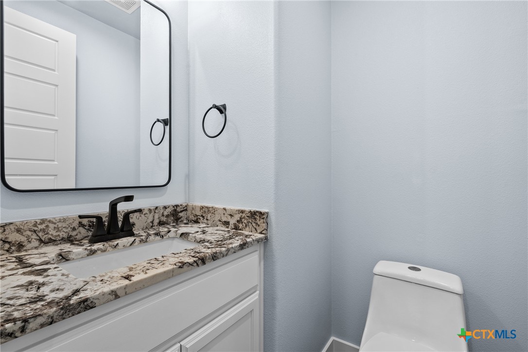 1606 Alta Vista Loop Temple, TX 76502 - Photo 18 of 48 a bathroom with a granite countertop sink and a mirror