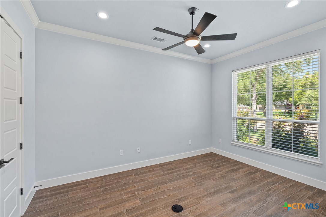 1606 Alta Vista Loop Temple, TX 76502 - Photo 19 of 48 a view of an empty room with wooden floor and a window