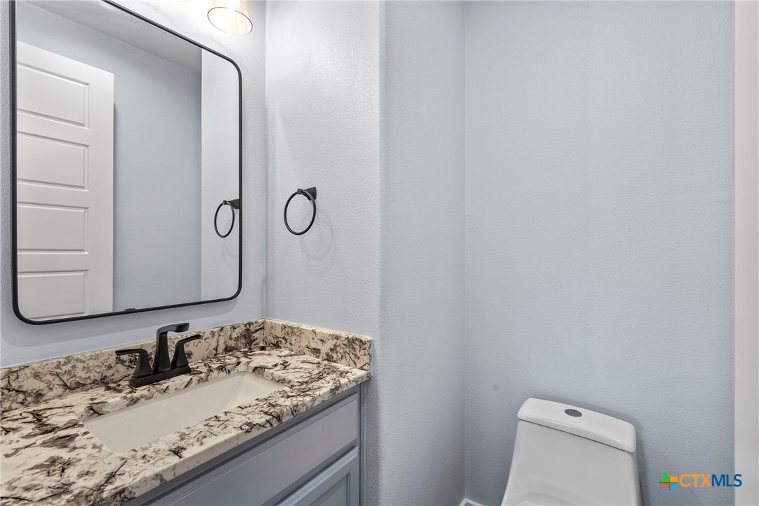 1606 Alta Vista Loop Temple, TX 76502 - Photo 21 of 48 a bathroom with a granite countertop sink and a mirror