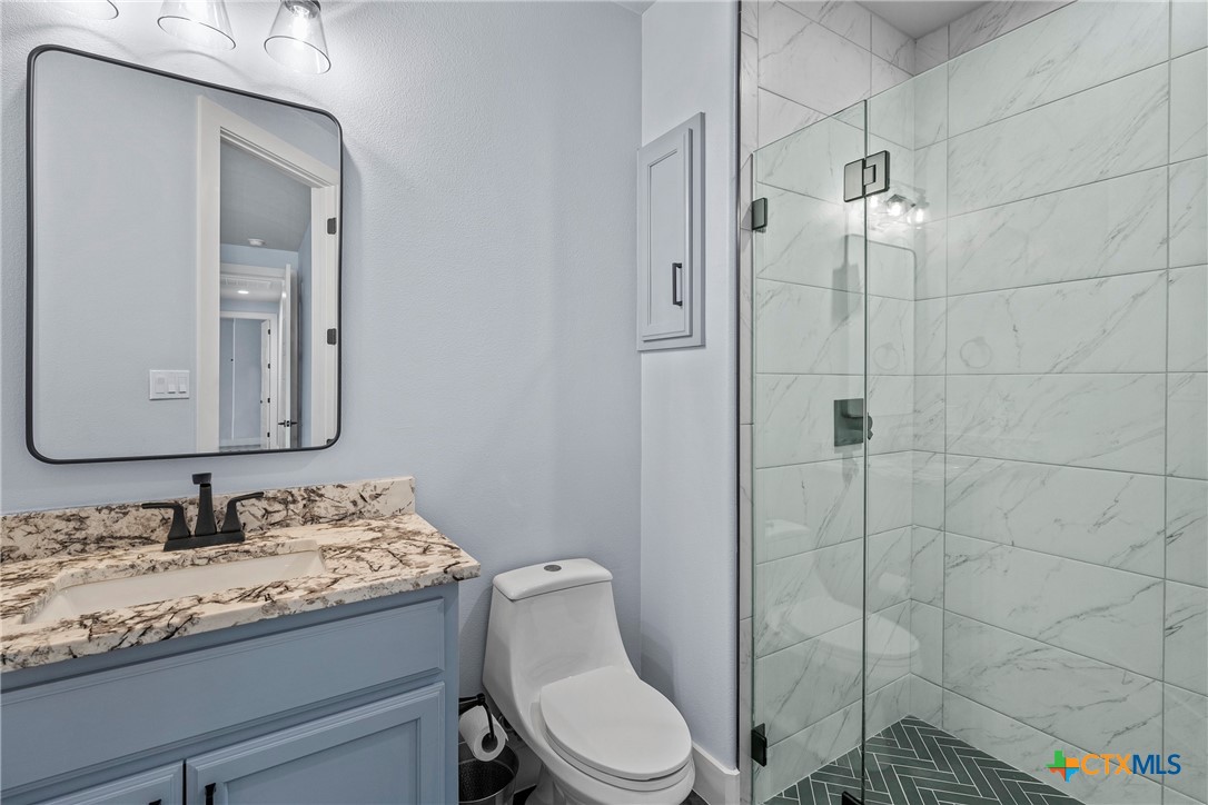 1606 Alta Vista Loop Temple, TX 76502 - Photo 28 of 48 a bathroom with a granite countertop sink toilet and shower