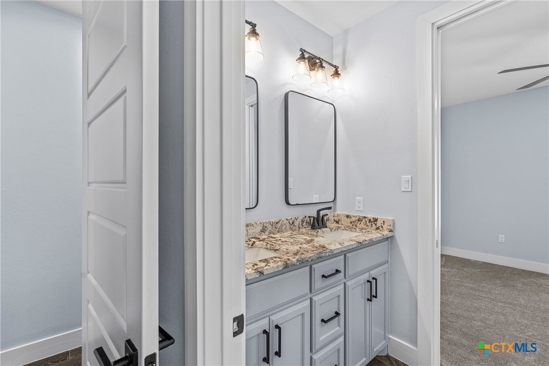 1606 Alta Vista Loop Temple, TX 76502 - Photo 30 of 48 a bathroom with a granite countertop sink and a mirror