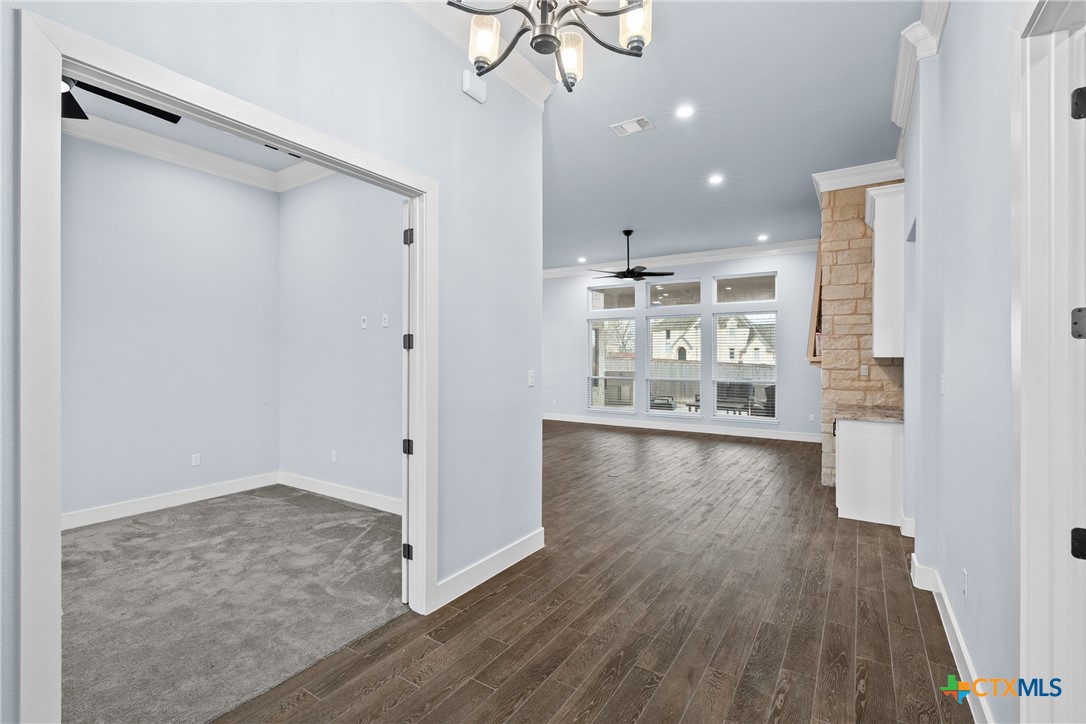 1606 Alta Vista Loop Temple, TX 76502 - Photo 3 of 48 a view of a kitchen with wooden floor and a ceiling fan