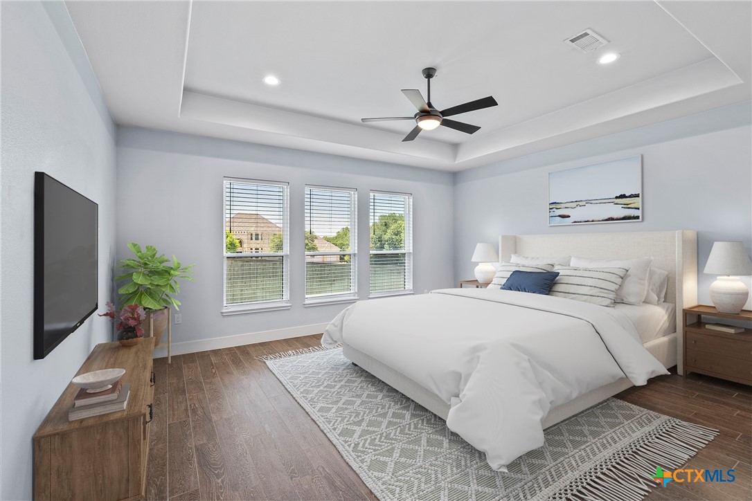 1606 Alta Vista Loop Temple, TX 76502 - Photo 4 of 48 a bedroom with a large bed and a flat tv screen