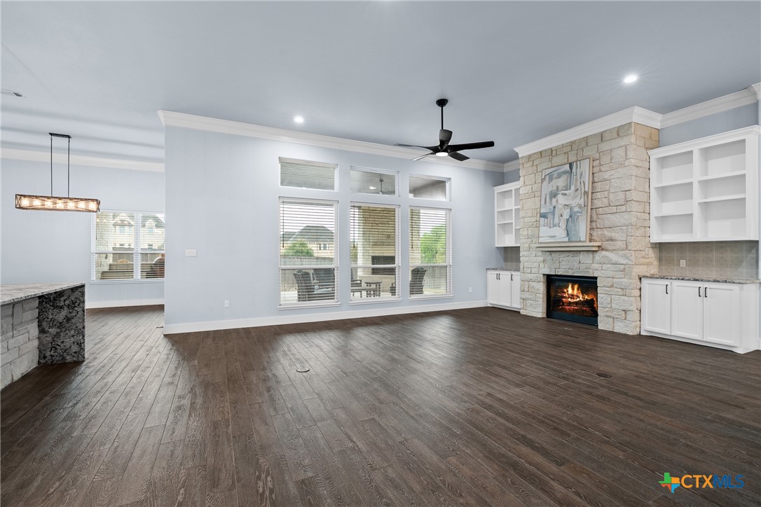 1606 Alta Vista Loop Temple, TX 76502 - Photo 10 of 48 an empty room with wooden floor fireplace and windows